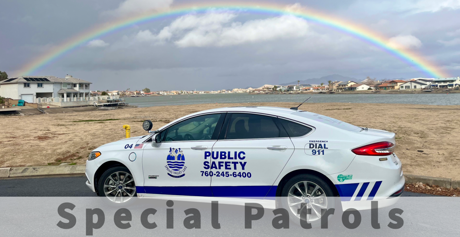PSD car under rainbow with lake SVL lake in the background